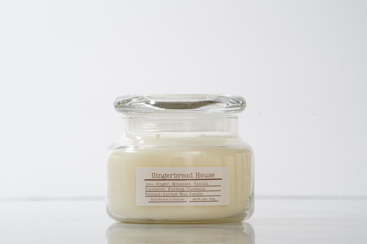 Gingerbread House labeled scented glass candle with lid