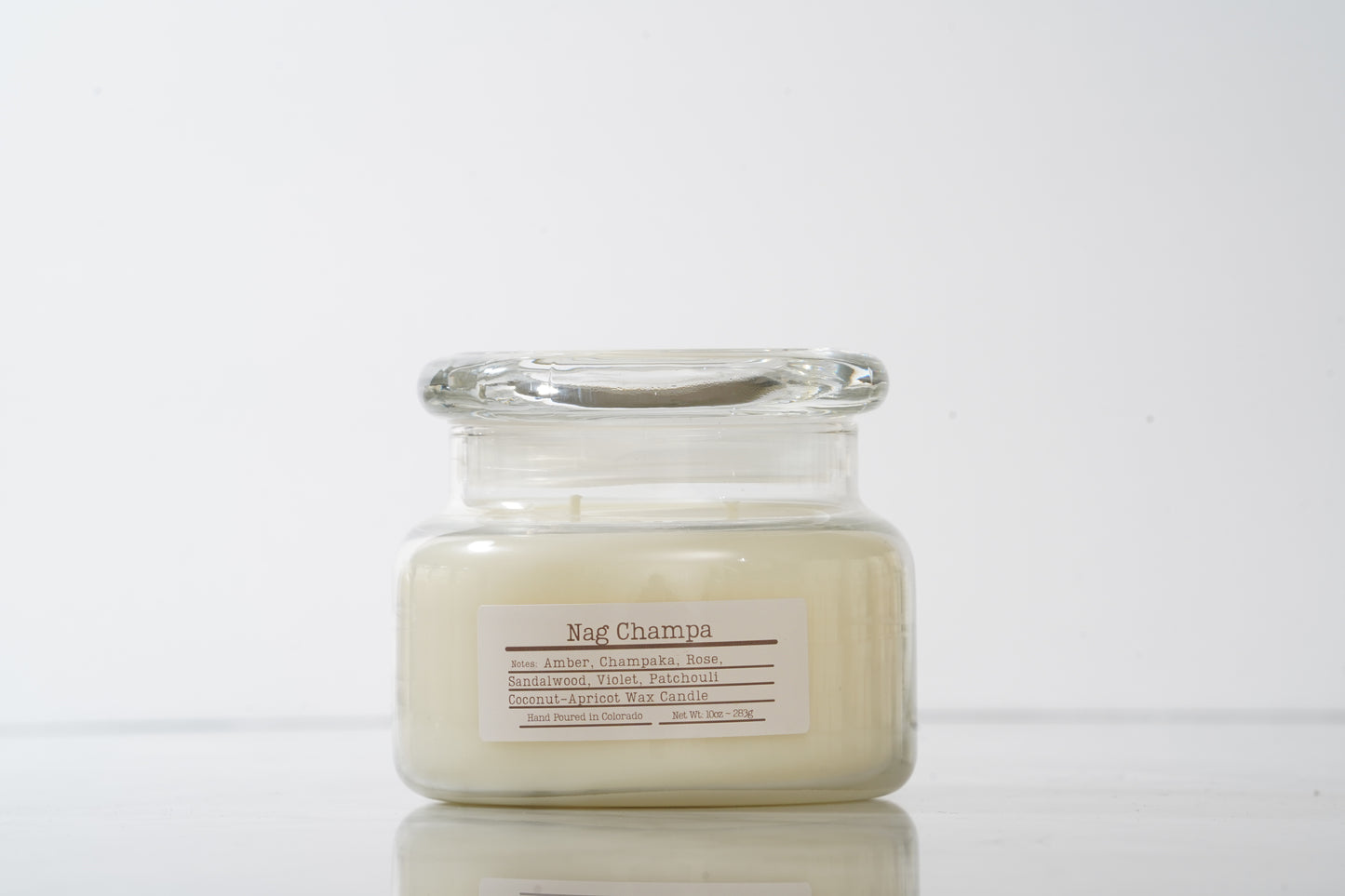 Glass jarred candle labeled Nag Champa