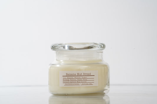 Glass jar scented candle labeled Banana Nut Bread