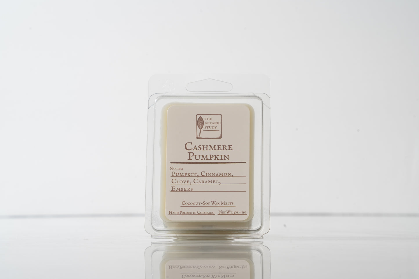 Cashmere Pumpkin wax melt in a clear container on a white background