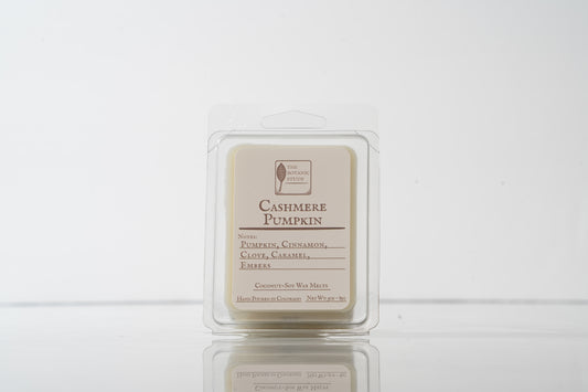 Cashmere Pumpkin wax melt in a clear container on a white background