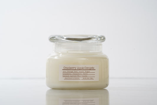 Jar candle labeled 'Cranberry Apple Compote' on a white background