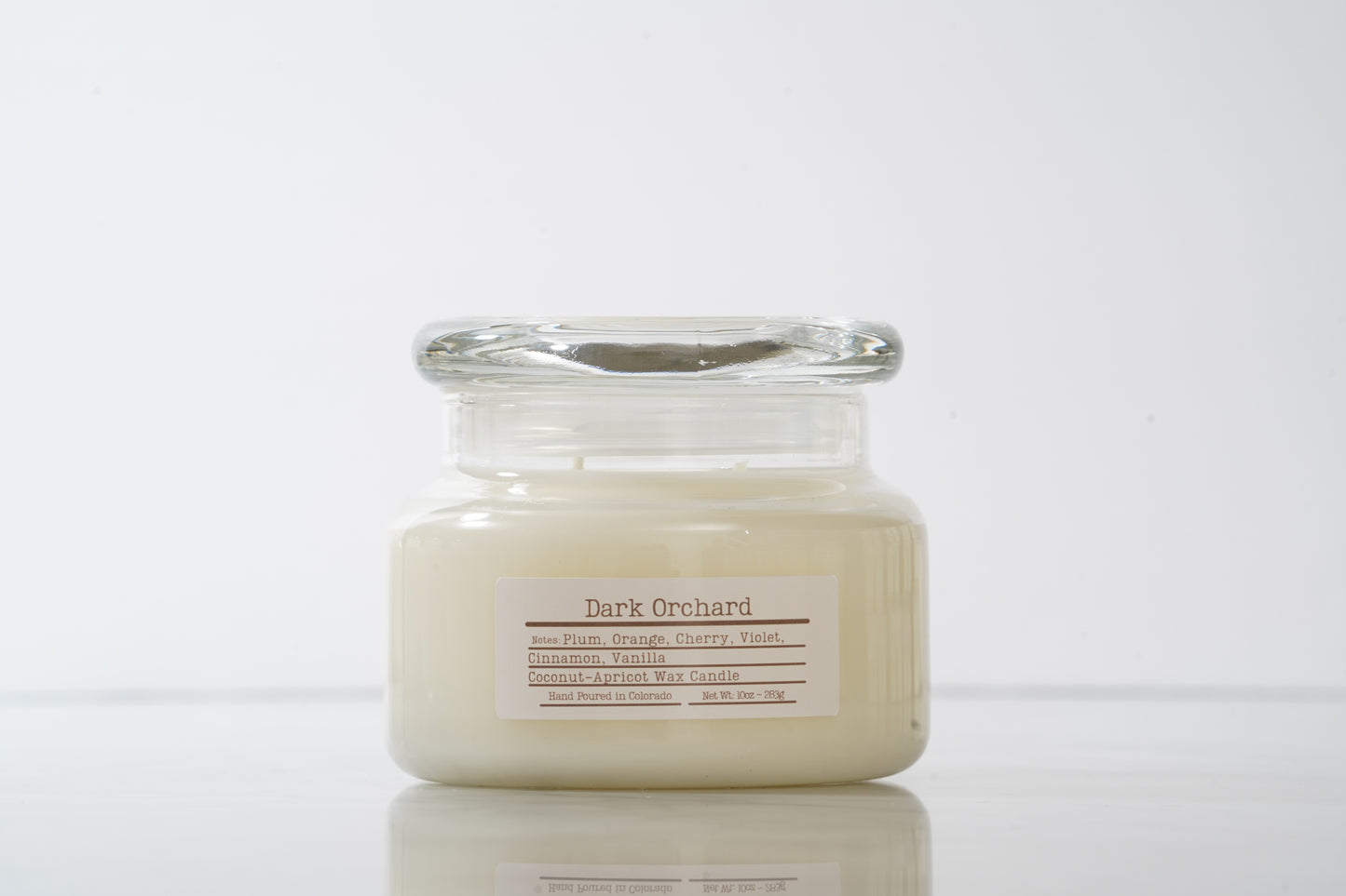 Dark Orchard labeled glass scented candle with lid