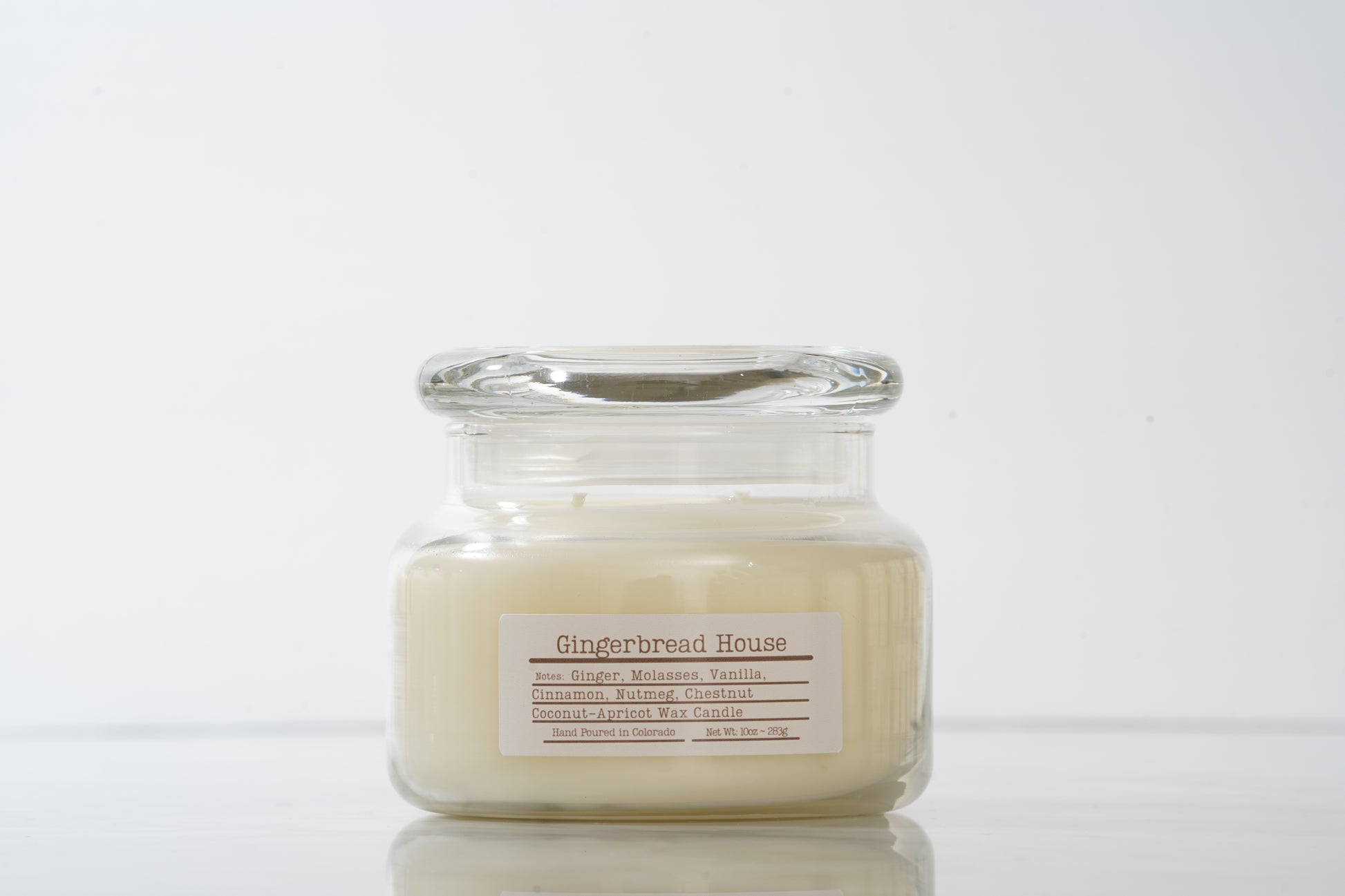 Gingerbread House labeled scented glass candle with lid