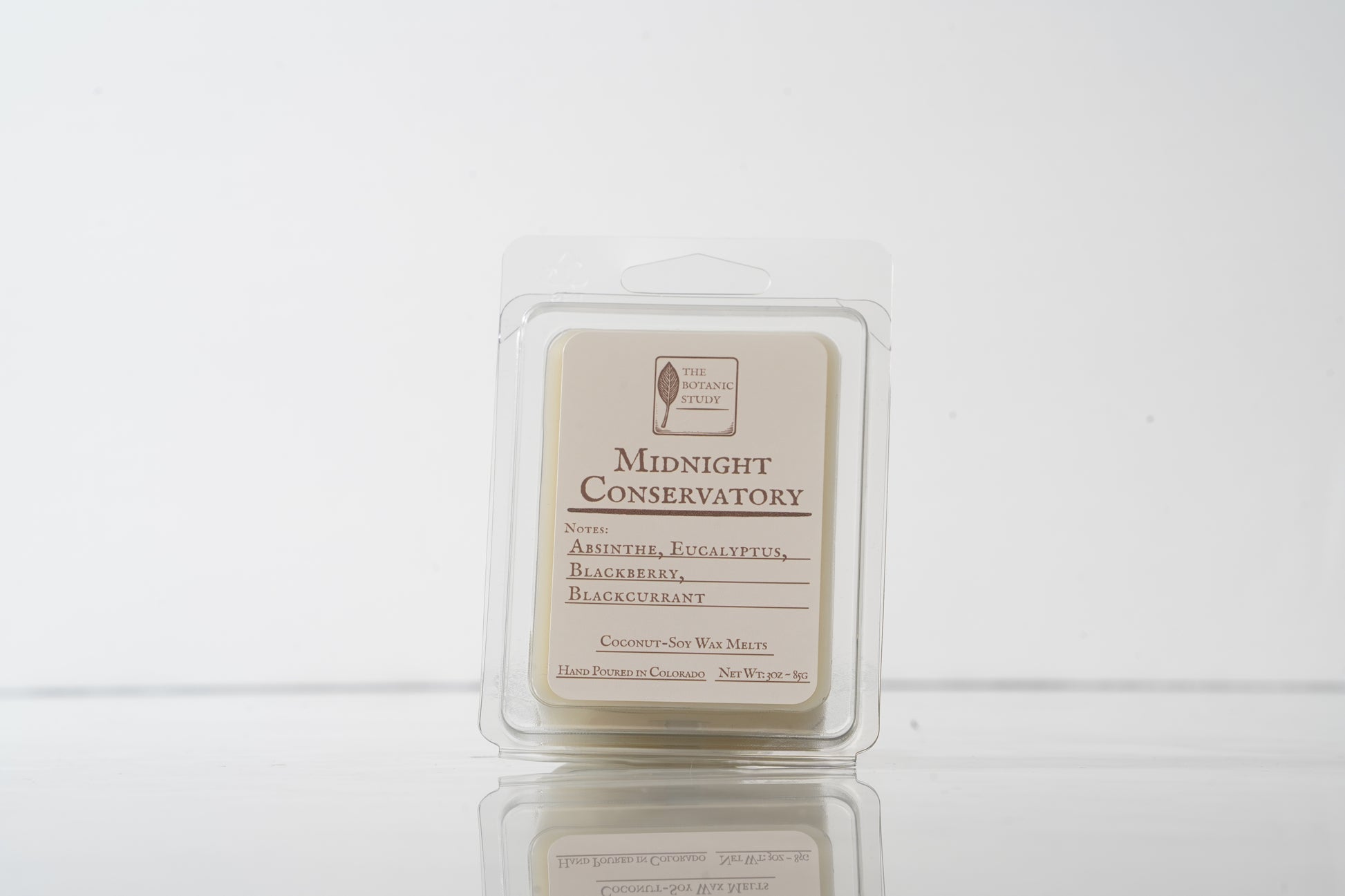 Wax melt container labeled 'Midnight Conservatory' on a white background