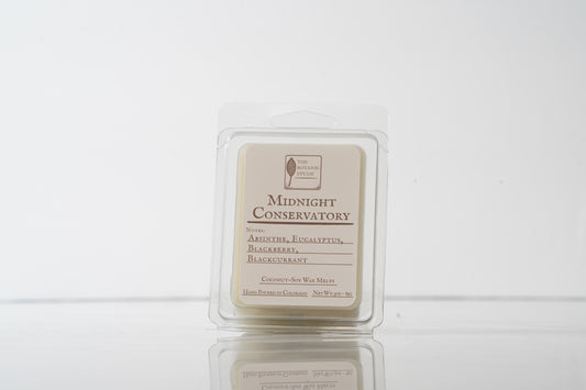 Wax melt container labeled 'Midnight Conservatory' on a white background