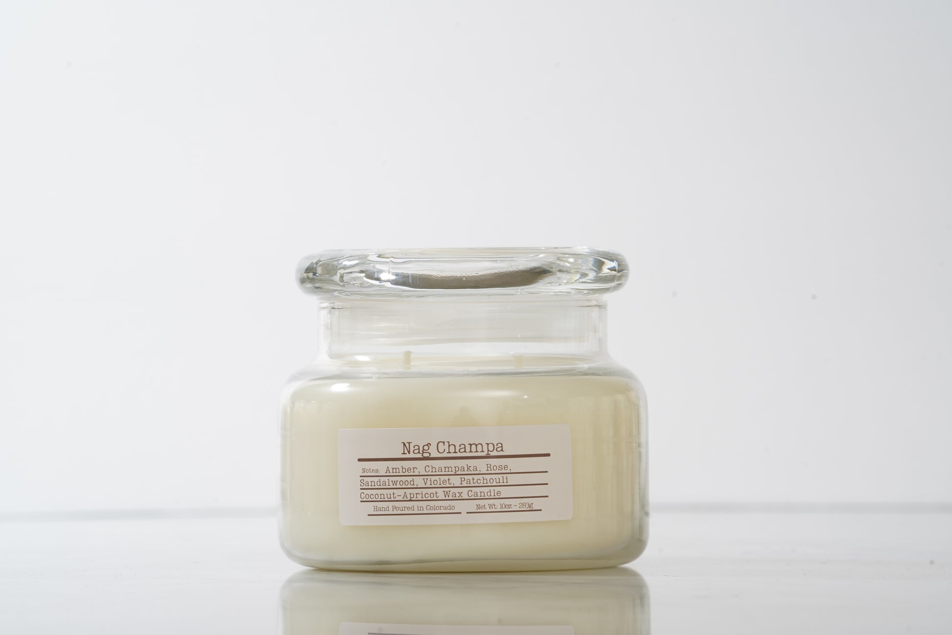 Glass jarred candle labeled Nag Champa