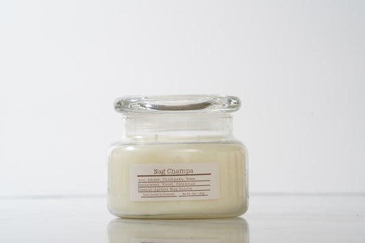 Glass jarred candle labeled Nag Champa